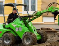 Avant with auger digging post hole