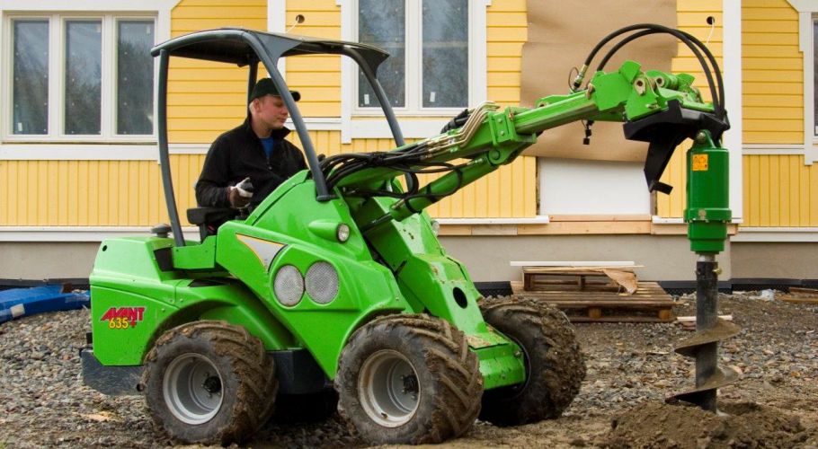 Avant with auger digging post hole